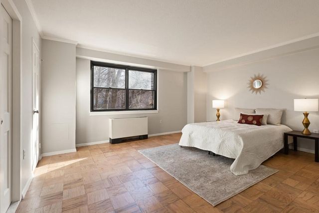 a spacious bedroom with a large bed and a window