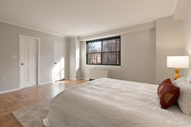 a bedroom with a bed and a lamp