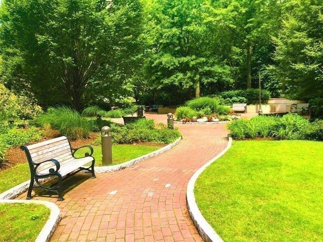 a view of a swimming pool with lawn chairs under an umbrella
