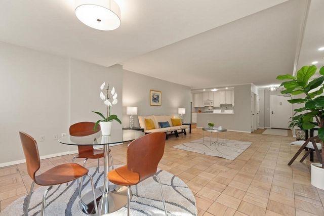 a view of a dining room with furniture and a potted plant