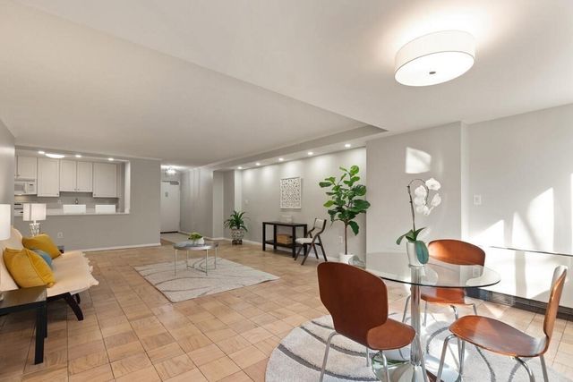 a living room with furniture a mirror and a table