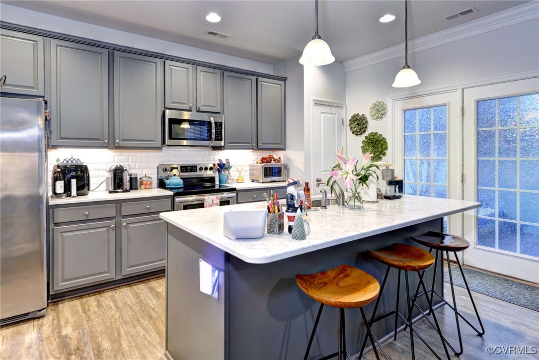 325 Martin Farm Road Yorktown, VA 23692 - Photo 15 of 50 Kitchen featuring decorative light fixtures, stain