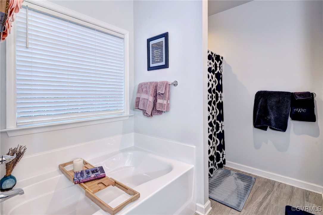 325 Martin Farm Road Yorktown, VA 23692 - Photo 23 of 50 Bathroom with a washtub and hardwood / wood-style