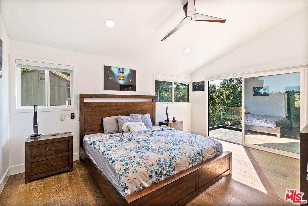 4118 Oak Hollow Road Calabasas, CA 91302 - Photo 35 of 55 a bedroom with a large bed and a flat tv screen