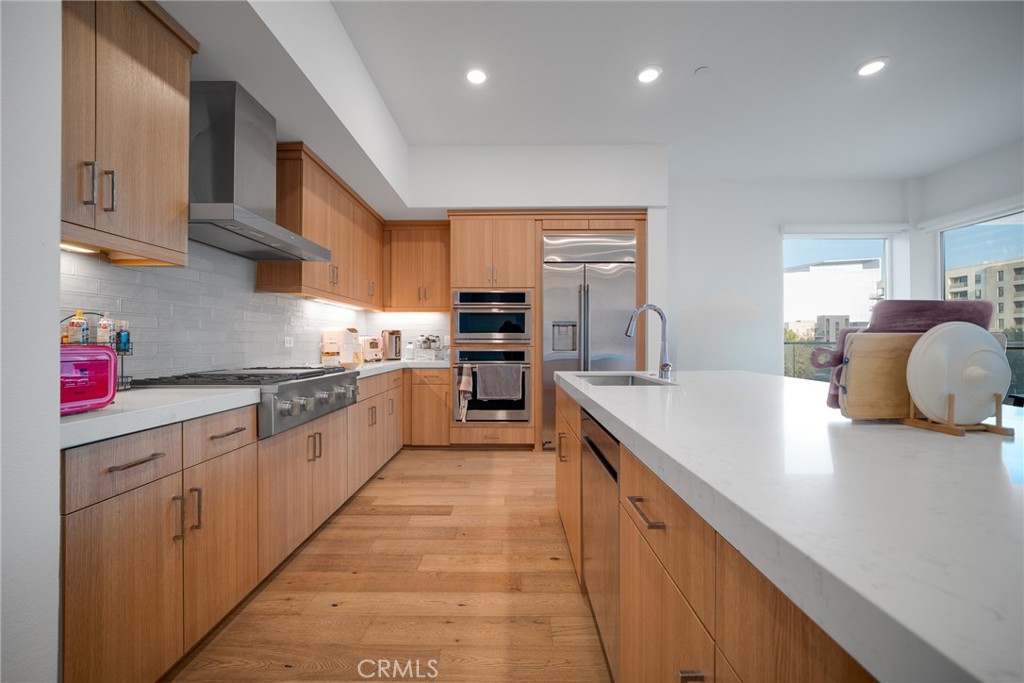 1310 Rivington Irvine, CA 92612 - Photo 1 of 20 a large kitchen with stainless steel appliances granite countertop a sink counter space and a stove top oven