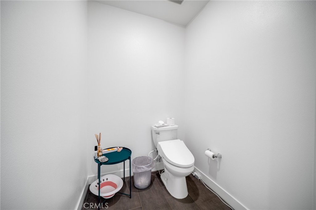 1310 Rivington Irvine, CA 92612 - Photo 15 of 20 a white toilet sitting next to a white sink and vanity