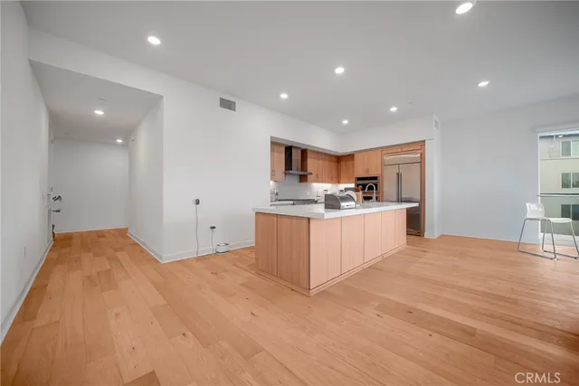 a large kitchen with kitchen island a sink stainless steel appliances and cabinets