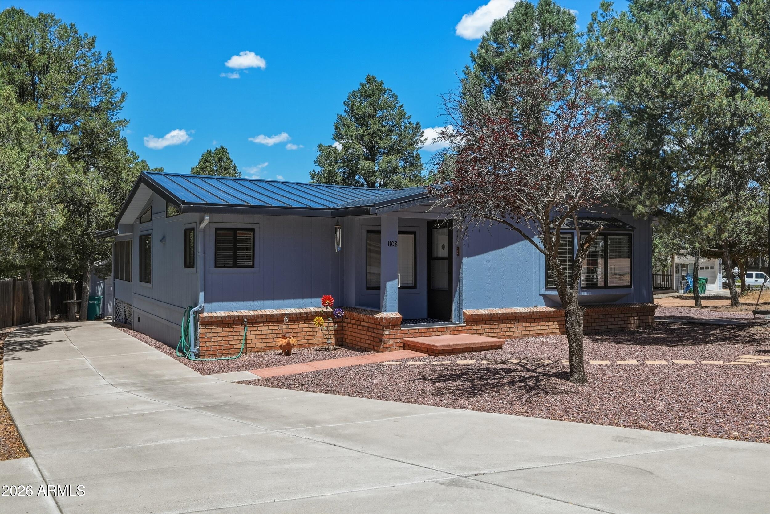 1108 North William Tell Circle Payson, AZ 85541 - Photo 2 of 32 a front view of a house with a yard and tree