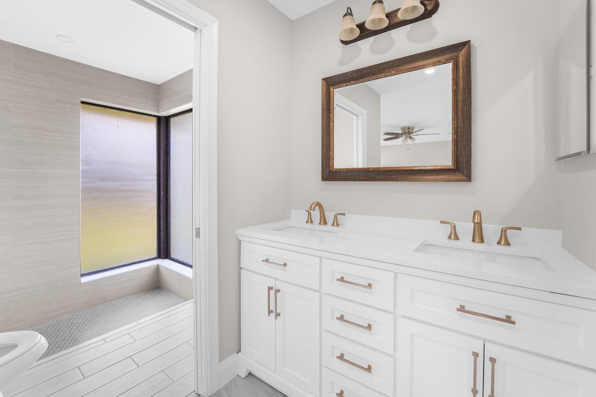 22207 Alyssum Way Boca Raton, FL 33433 - Photo 16 of 31 a bathroom with a granite countertop sink mirror vanity and toilet