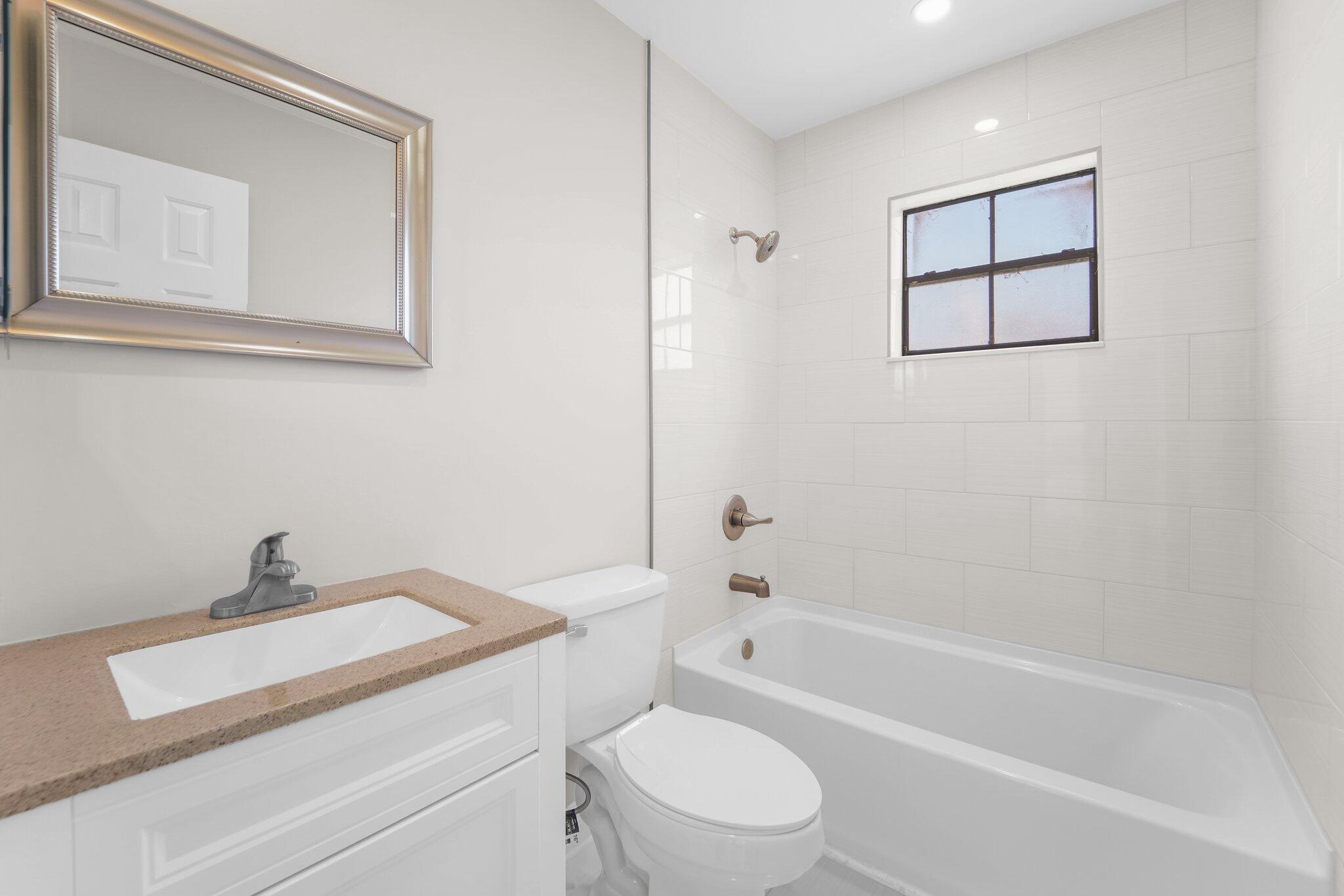 22207 Alyssum Way Boca Raton, FL 33433 - Photo 17 of 31 a bathroom with a sink a toilet and bathtub