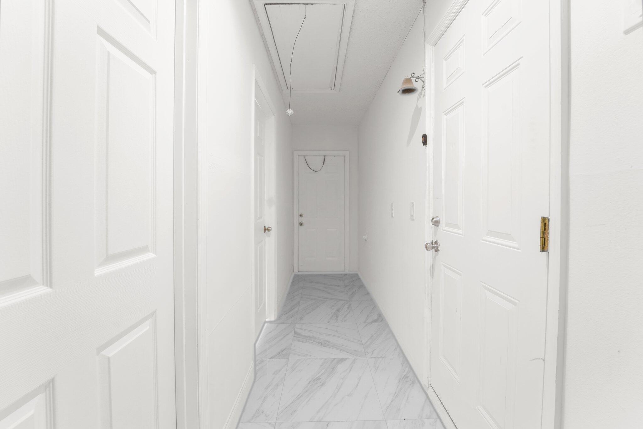 22207 Alyssum Way Boca Raton, FL 33433 - Photo 20 of 31 a view of a hallway with white walls