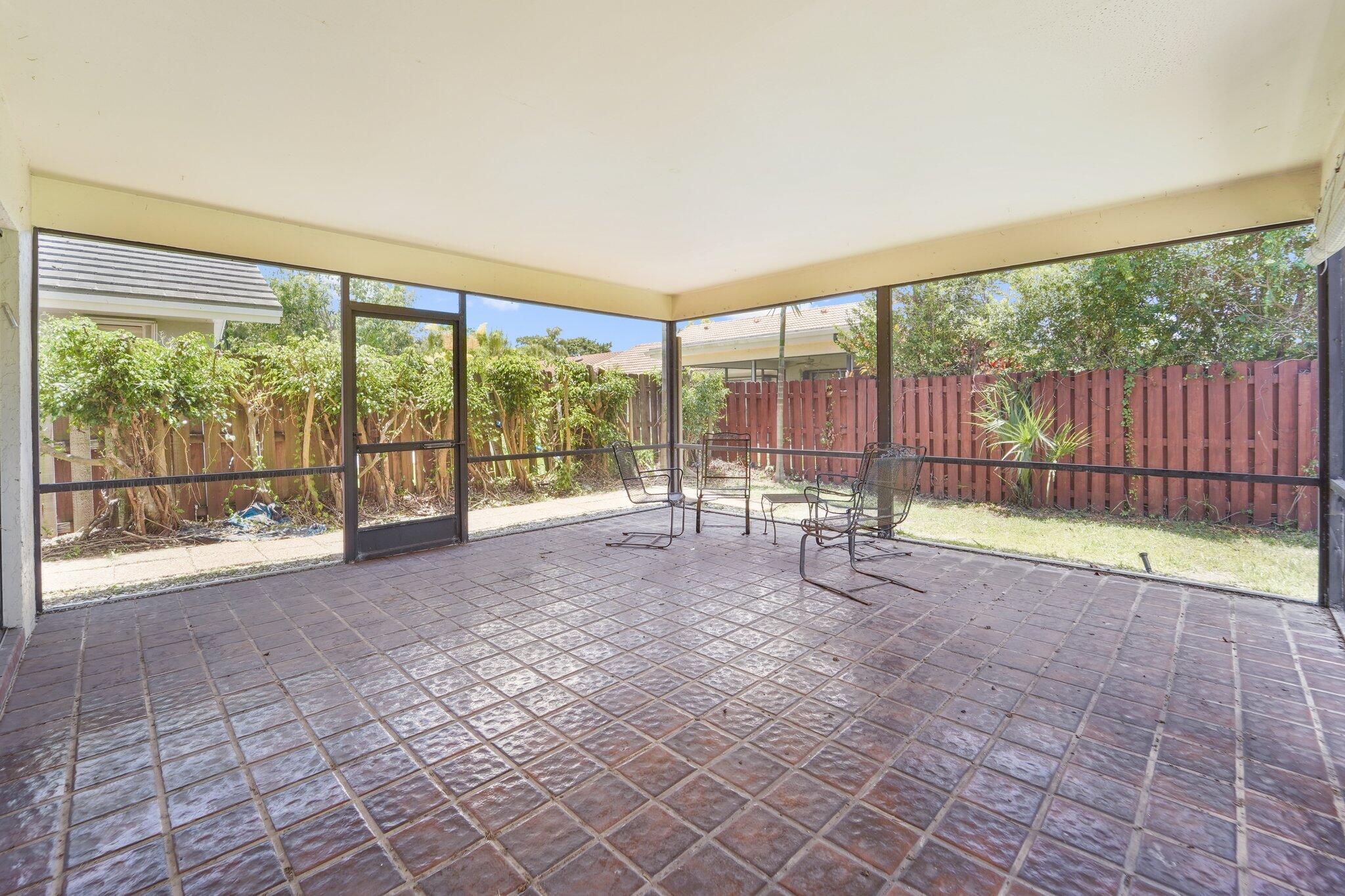 22207 Alyssum Way Boca Raton, FL 33433 - Photo 30 of 31 a view of empty room with wooden floor and iron fence