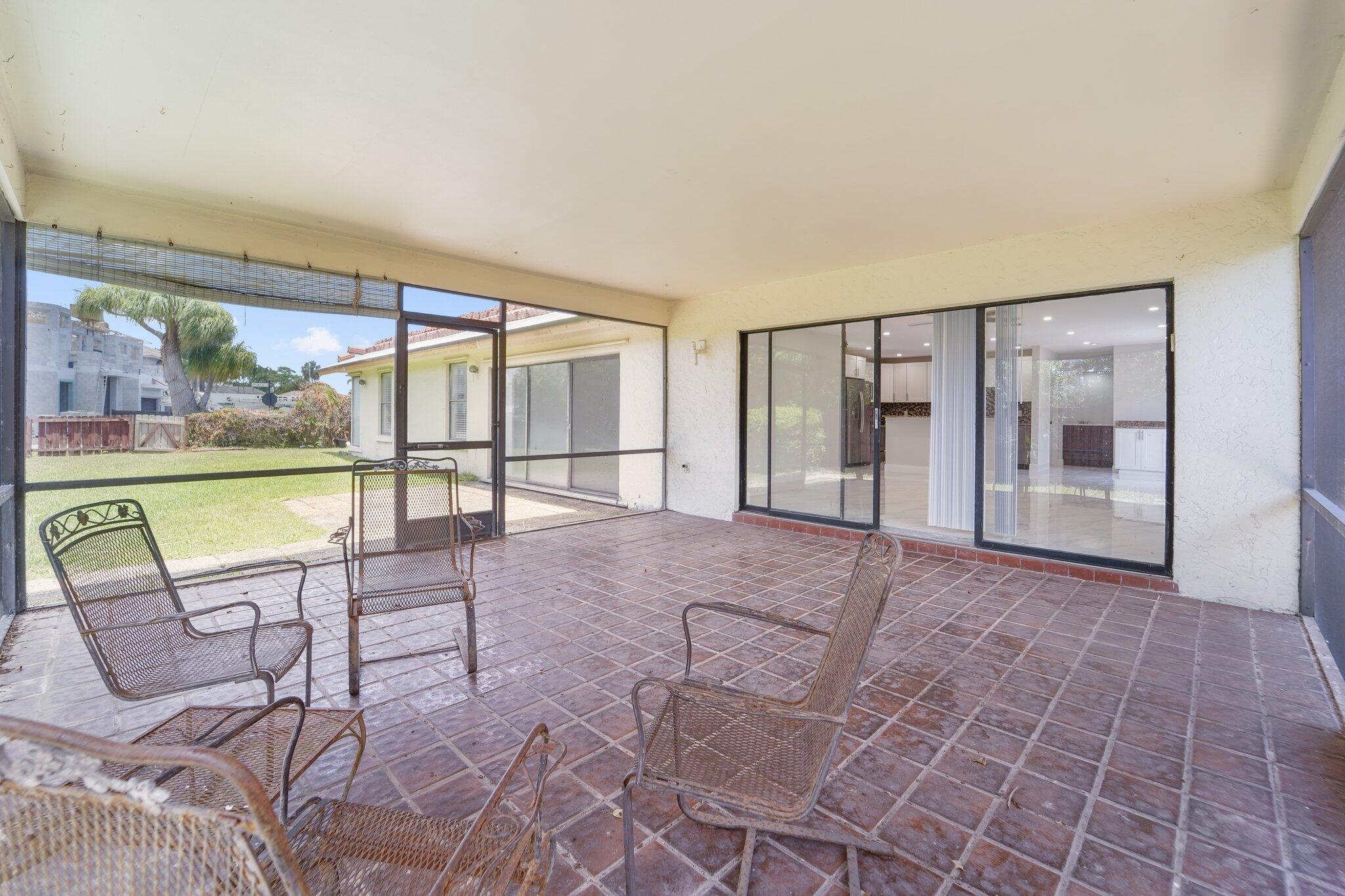 22207 Alyssum Way Boca Raton, FL 33433 - Photo 31 of 31 an empty room with floor to ceiling windows and city view