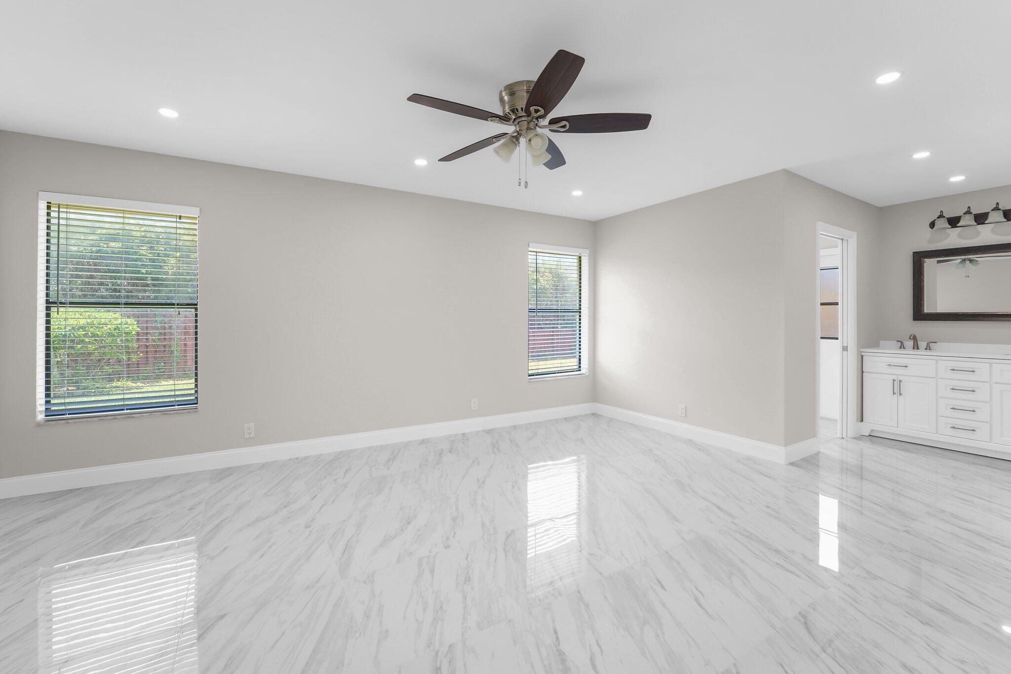 22207 Alyssum Way Boca Raton, FL 33433 - Photo 7 of 31 a view of an empty room with a window and wooden floor