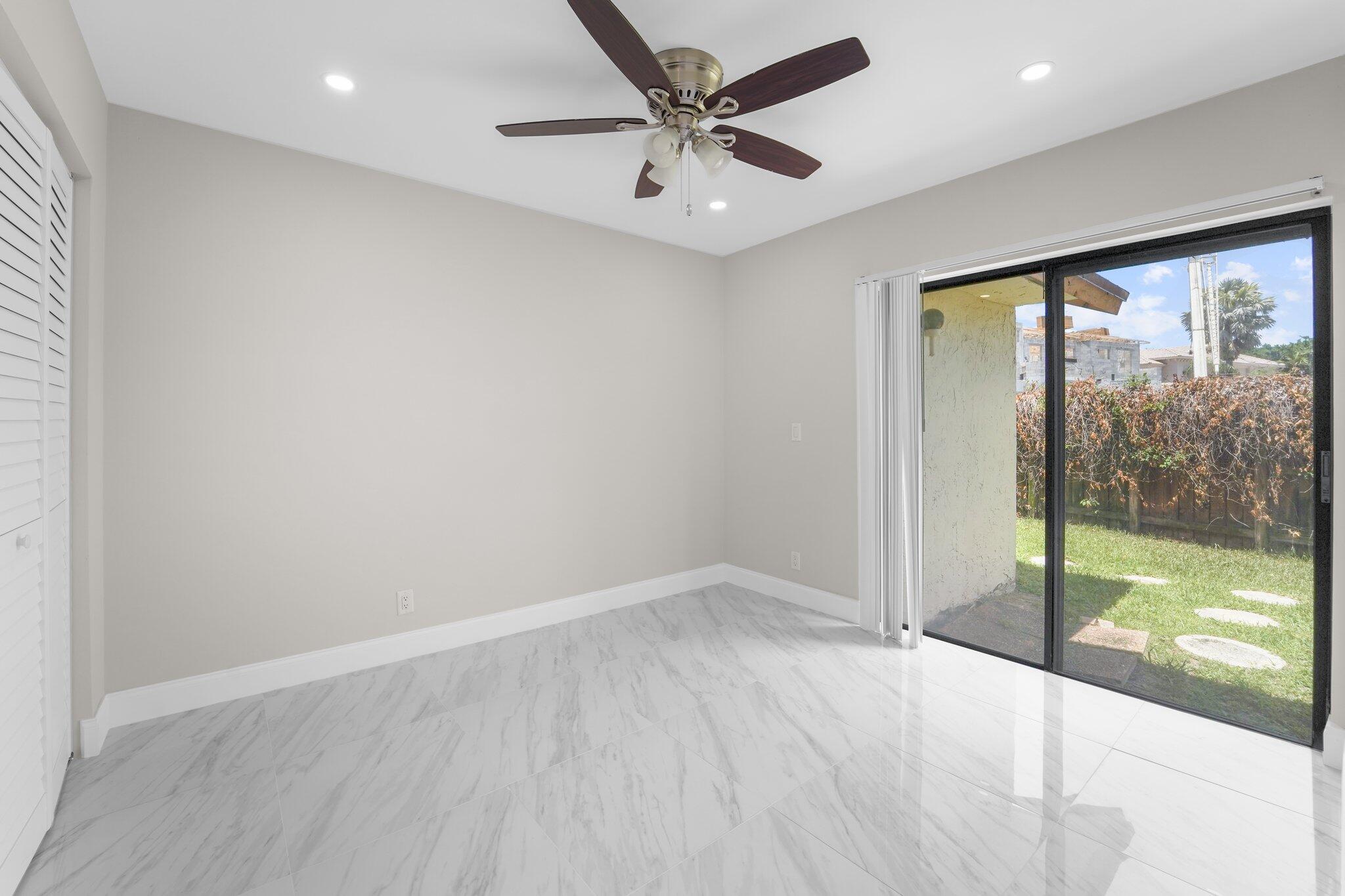 22207 Alyssum Way Boca Raton, FL 33433 - Photo 10 of 31 an empty room with wooden floor and fan