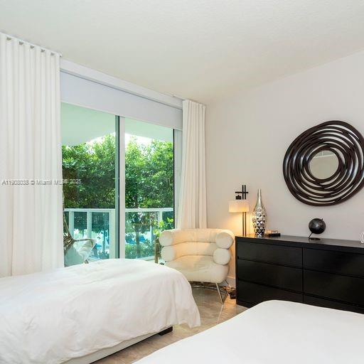 200 Sunny Isles Boulevard, Unit 2604 Sunny Isles Beach, FL 33160 - Photo 11 of 36 a bedroom with bed and a window