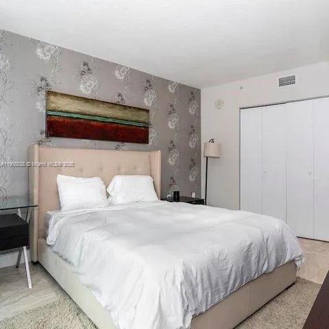 a bedroom with a bed and a closet