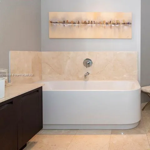 a white bath tub sitting in a bathroom