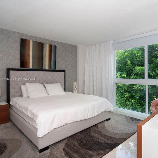 200 Sunny Isles Boulevard, Unit 2604 Sunny Isles Beach, FL 33160 - Photo 17 of 36 a bedroom with a bed and window