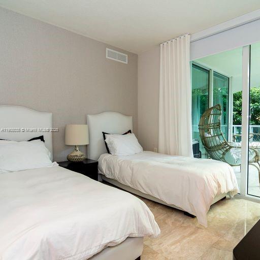 200 Sunny Isles Boulevard, Unit 2604 Sunny Isles Beach, FL 33160 - Photo 21 of 36 a bedroom with two beds and large window