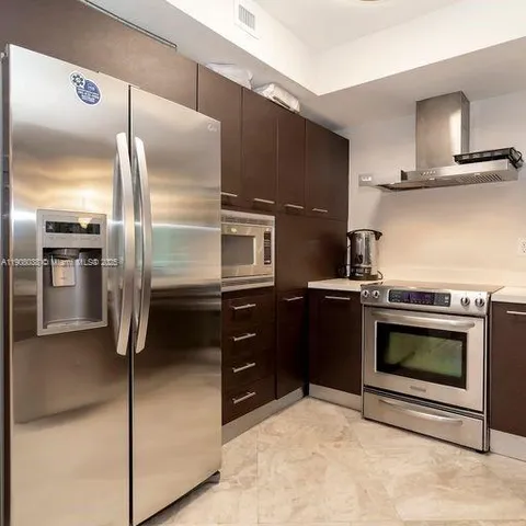 a kitchen with stainless steel appliances and a counter top