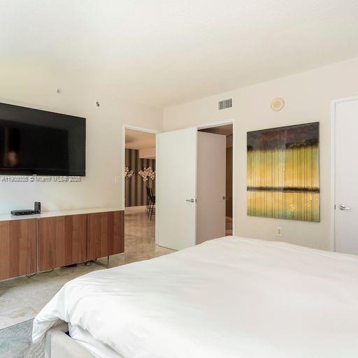 200 Sunny Isles Boulevard, Unit 2604 Sunny Isles Beach, FL 33160 - Photo 34 of 36 a bedroom with a bed and a flat screen tv