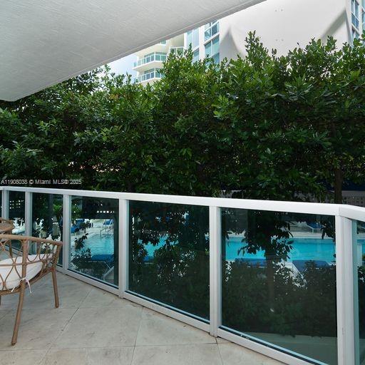 200 Sunny Isles Boulevard, Unit 2604 Sunny Isles Beach, FL 33160 - Photo 36 of 36 a balcony with tall trees in front of it