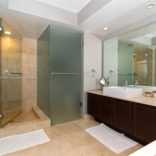 200 Sunny Isles Boulevard, Unit 2604 Sunny Isles Beach, FL 33160 - Photo 6 of 36 a bathroom with a sink and mirror