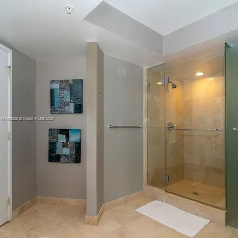 a bathroom with a shower and a sink