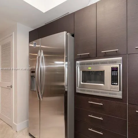 a kitchen with a refrigerator and a microwave