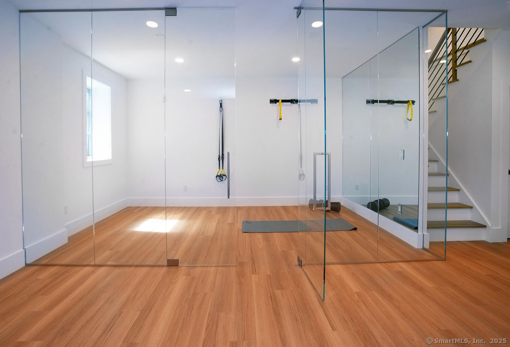 6 Down River Road, Unit B New Canaan, CT 06840 - Photo 31 of 39 Lower Level Gym with Glass Enclosure and Large Playroon