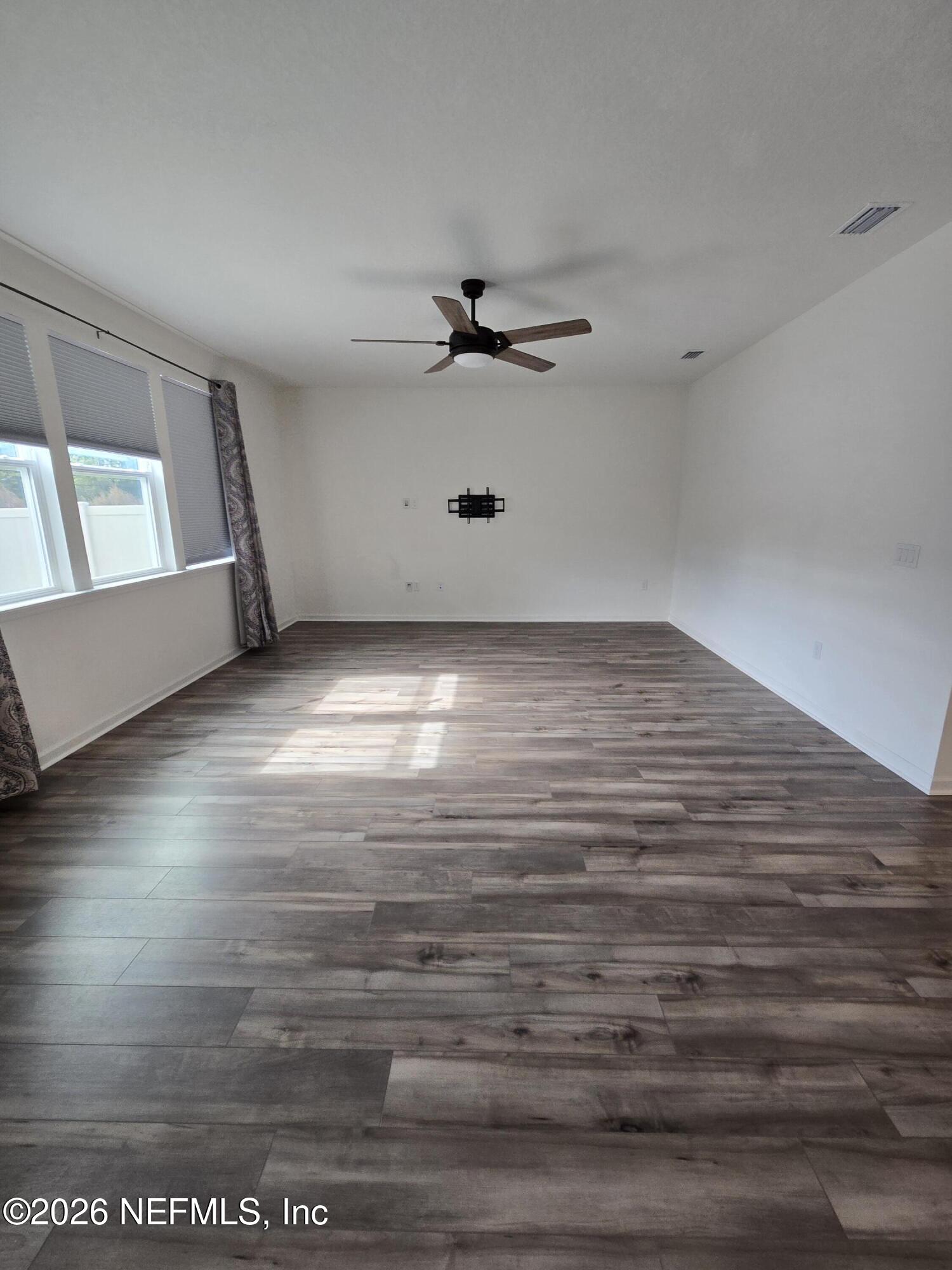 6788 Burnt Crk Road Jacksonville, FL 32222 - Photo 11 of 25 a view of an empty room with window and a ceiling fan
