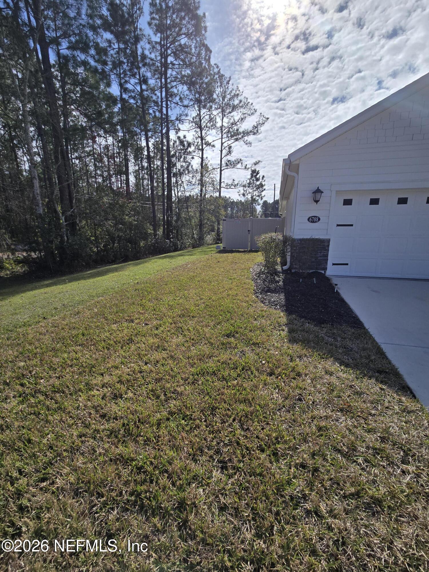 6788 Burnt Crk Road Jacksonville, FL 32222 - Photo 23 of 25 a view of a backyard with large trees
