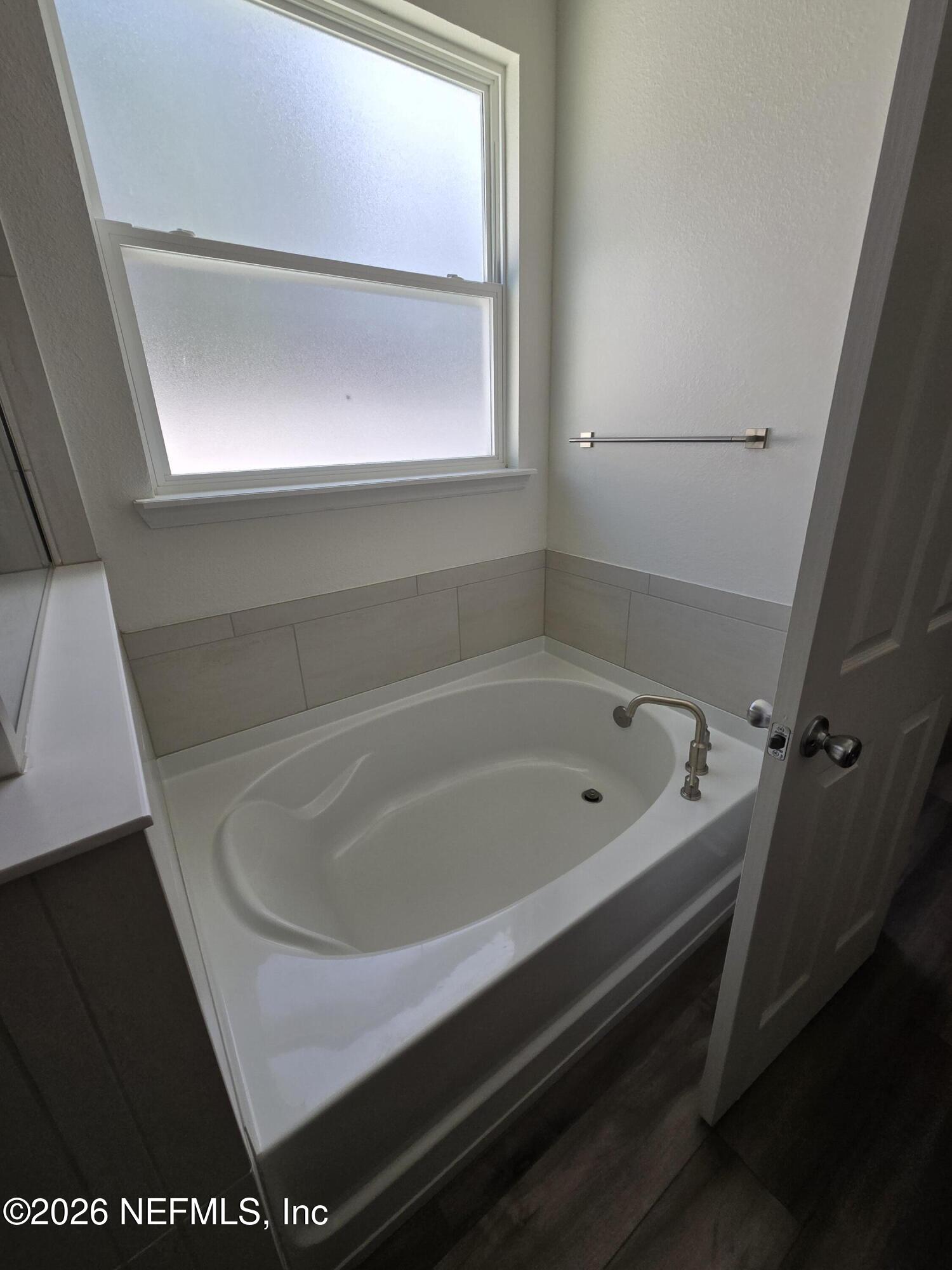 6788 Burnt Crk Road Jacksonville, FL 32222 - Photo 9 of 25 a bath tub sitting next to a window