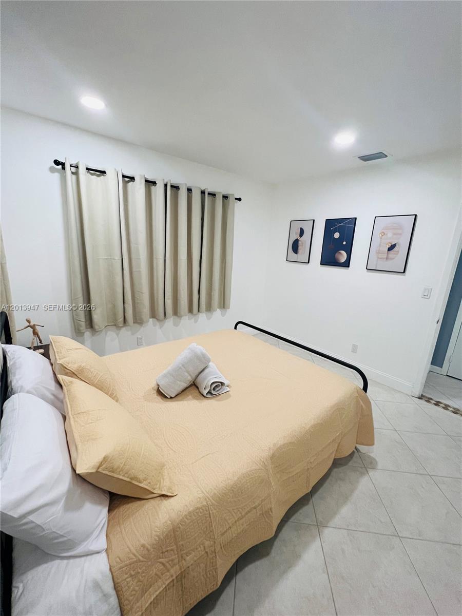 280 Northwest 55th Street, Unit 282 Miami, FL 33127 - Photo 13 of 19 a bed sitting in a bedroom and furniture
