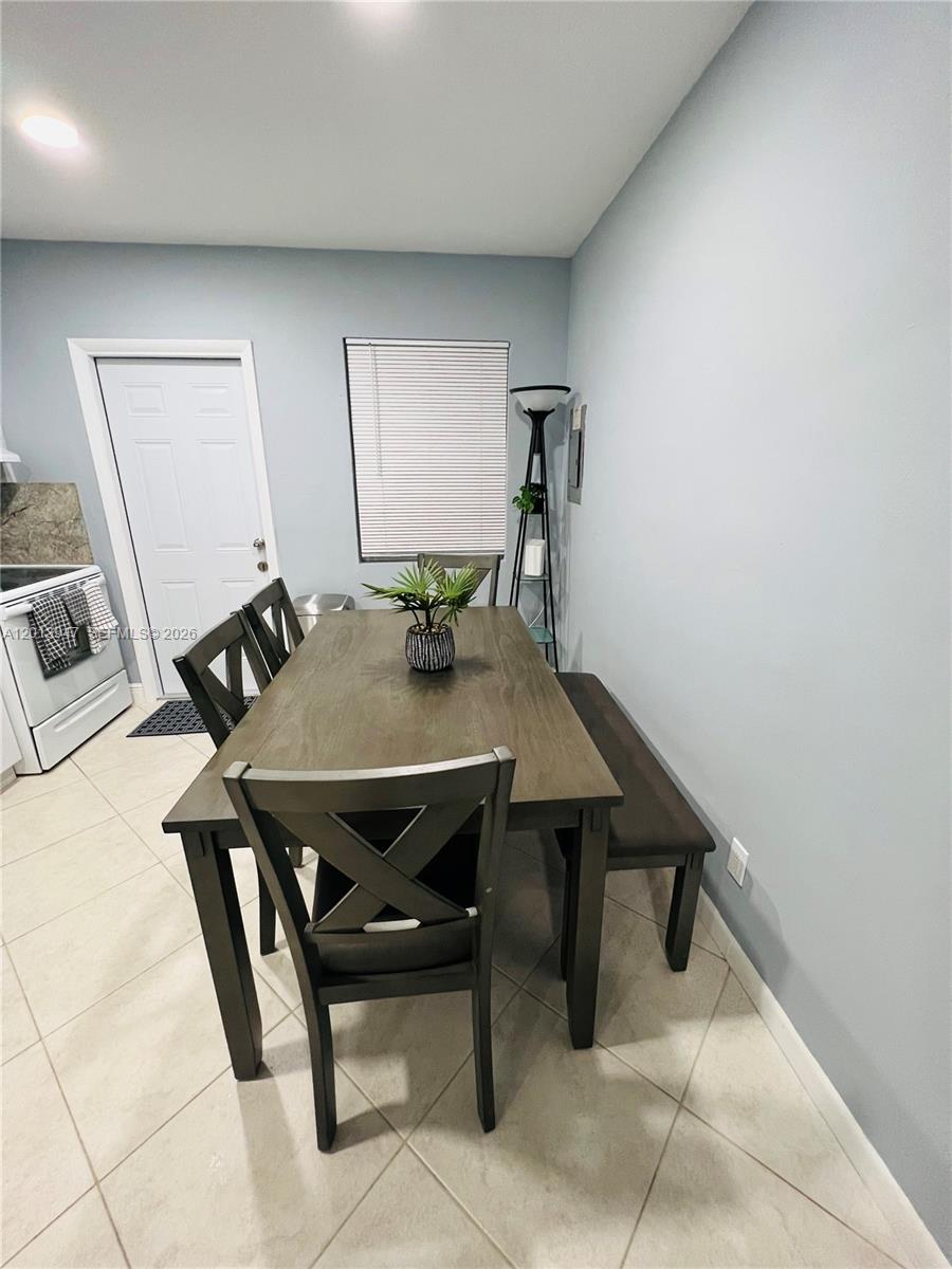 280 Northwest 55th Street, Unit 282 Miami, FL 33127 - Photo 14 of 19 a view of a dining room with furniture