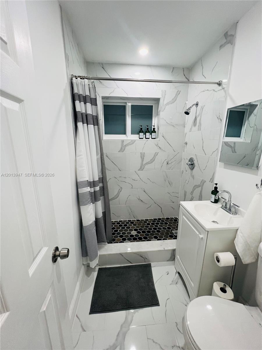 280 Northwest 55th Street, Unit 282 Miami, FL 33127 - Photo 17 of 19 a bathroom with a sink toilet and shower