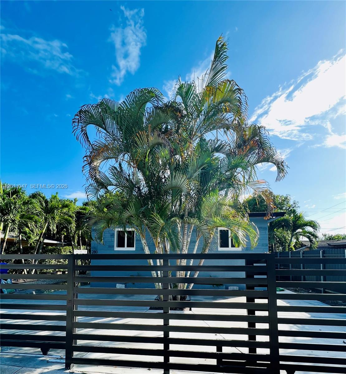 280 Northwest 55th Street, Unit 282 Miami, FL 33127 - Photo 2 of 19 a view of a house with a tree
