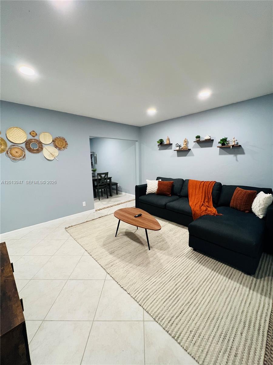 280 Northwest 55th Street, Unit 282 Miami, FL 33127 - Photo 3 of 19 a living room with furniture and painting on the wall