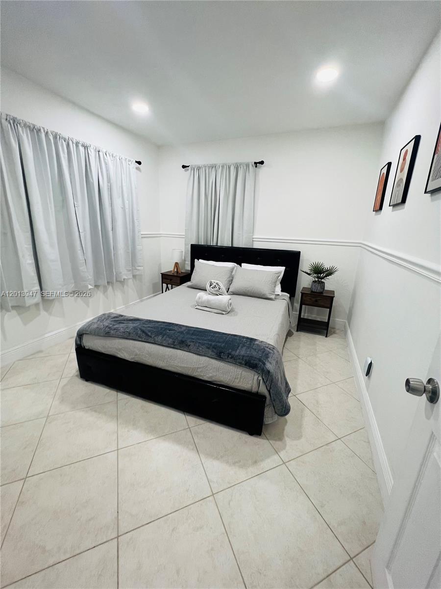 280 Northwest 55th Street, Unit 282 Miami, FL 33127 - Photo 7 of 19 a bedroom with a bed and a shower
