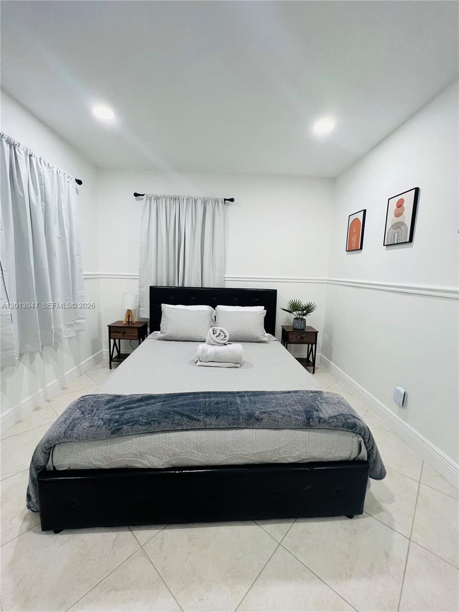 280 Northwest 55th Street, Unit 282 Miami, FL 33127 - Photo 9 of 19 a bedroom with a bed and window