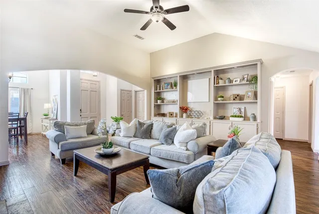 a living room with furniture and a book shelf
