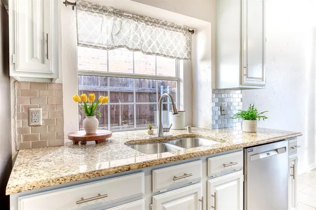 a kitchen with kitchen island a counter top space and a sink