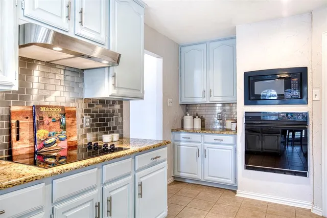 a kitchen with stainless steel appliances kitchen island granite countertop a sink and cabinets