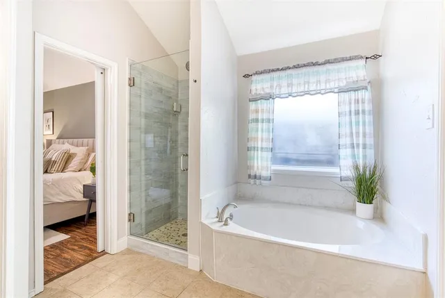 a bathroom with a bathtub and a shower