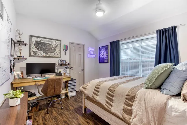 a bedroom with a bed and a desk