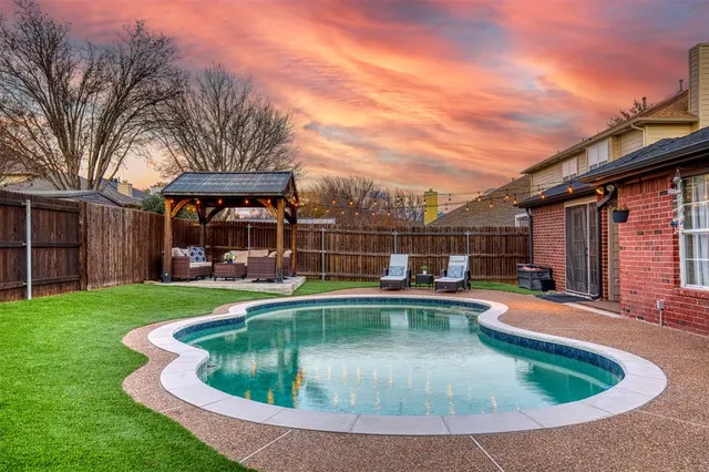 a view of a house with swimming pool and sitting area