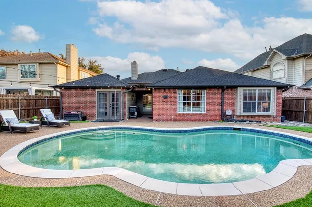 a view of a house with swimming pool and sitting area