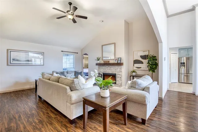 a living room with furniture a fireplace and a potted plant