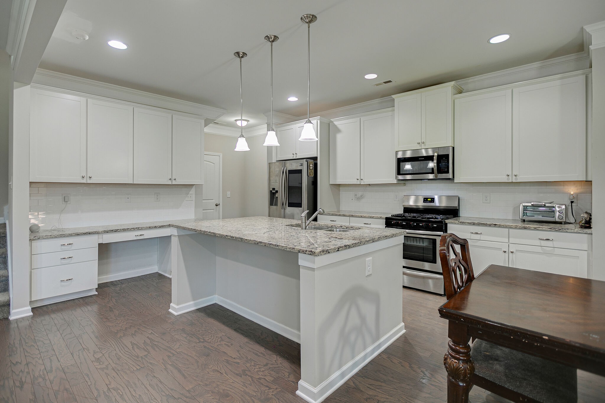 966 Carnation Drive Spring Hill, TN 37174 - Photo 13 of 31 a kitchen with granite countertop white cabinets and appliances